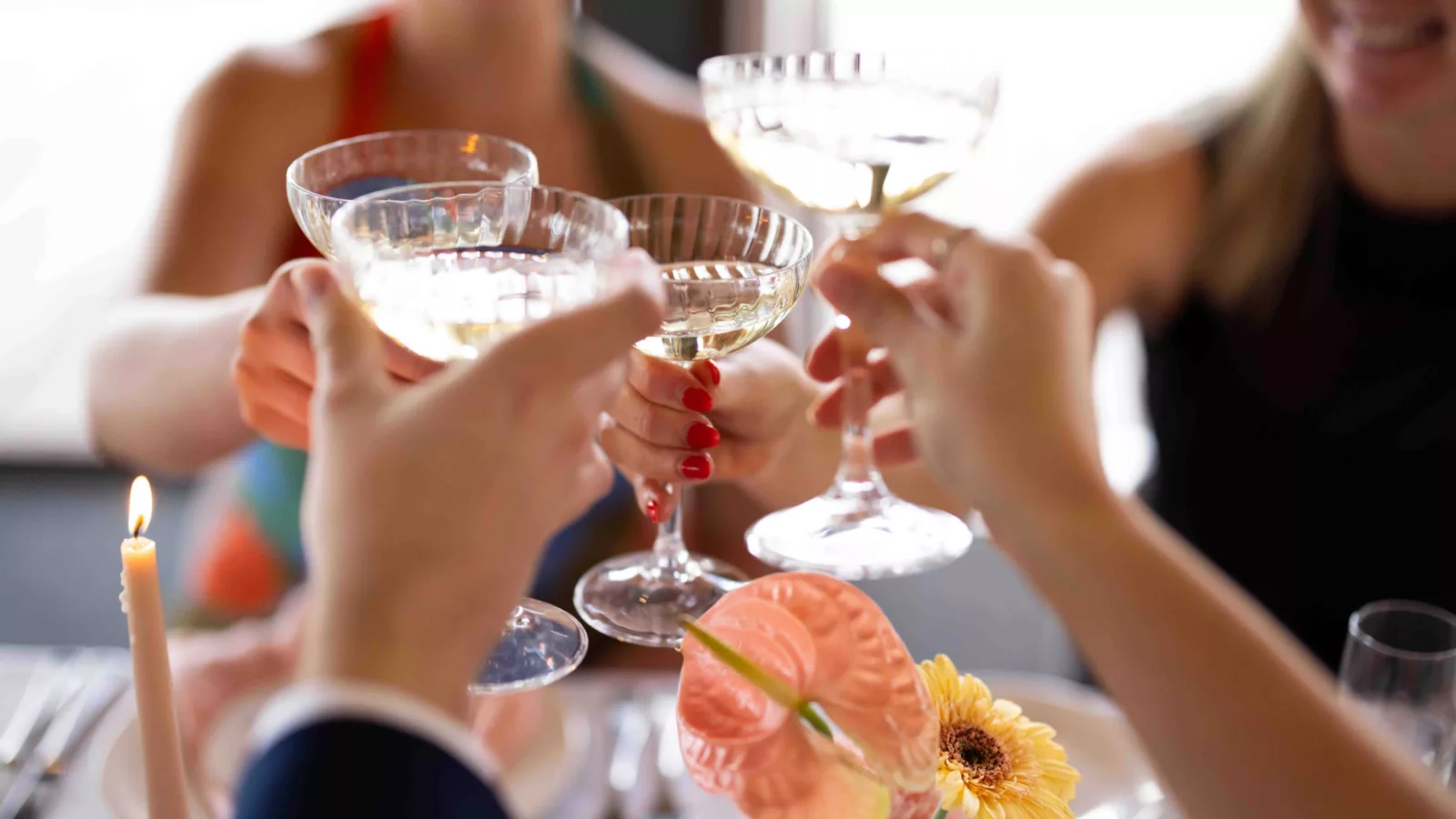 Group of friends raising their champagne glasses as a toast