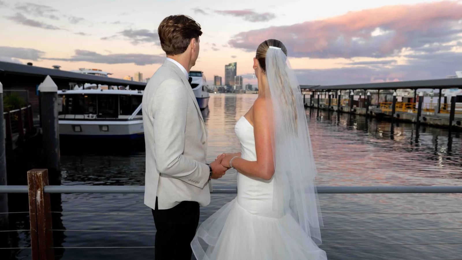 Wedding couple looking out to the Swan River from boardwalk outside Bells Functions