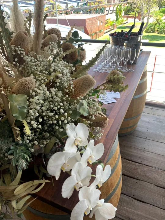 Flower arrangement set on wine barrels