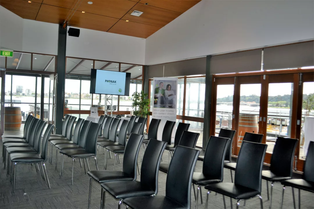 Function room set for a corporate presentation with rows of chairs