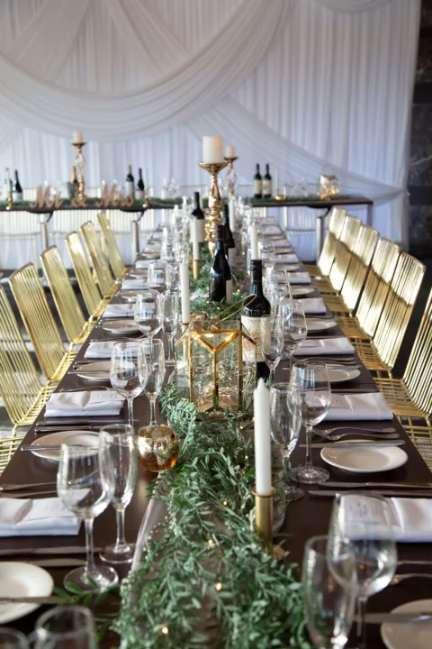 A long table set for a wedding with decorations and candles