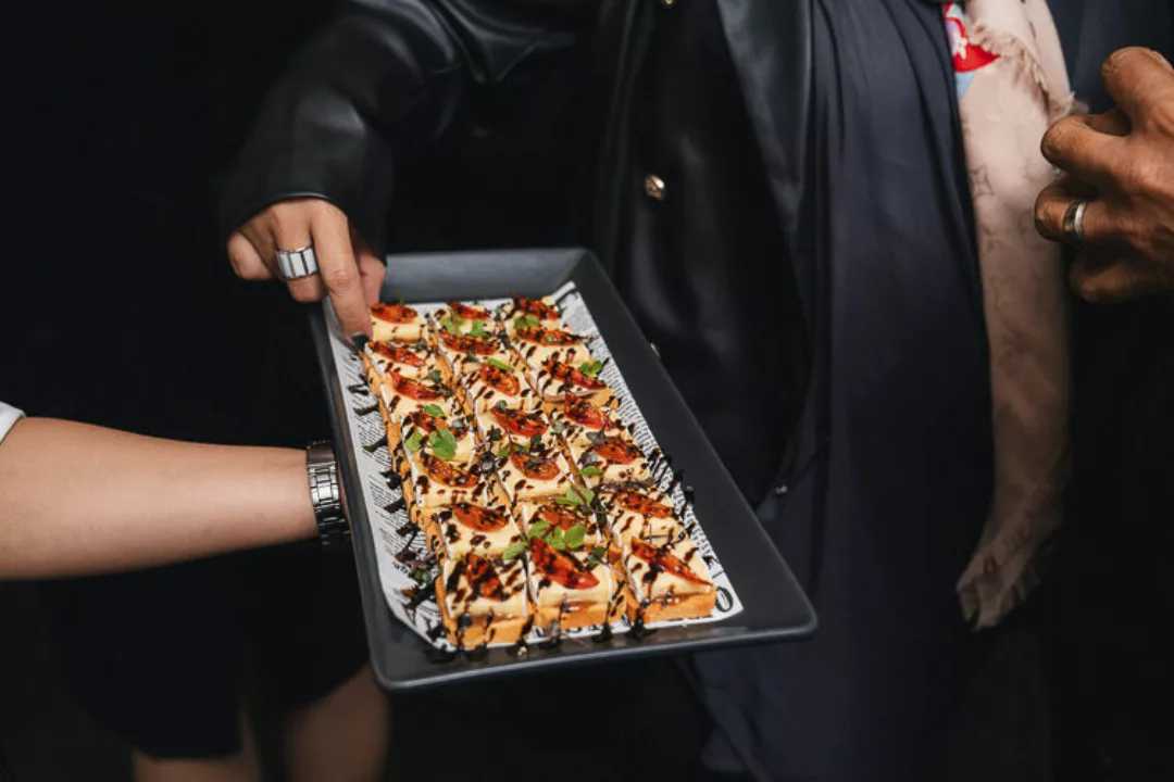 Waiter offers canapes to function guests