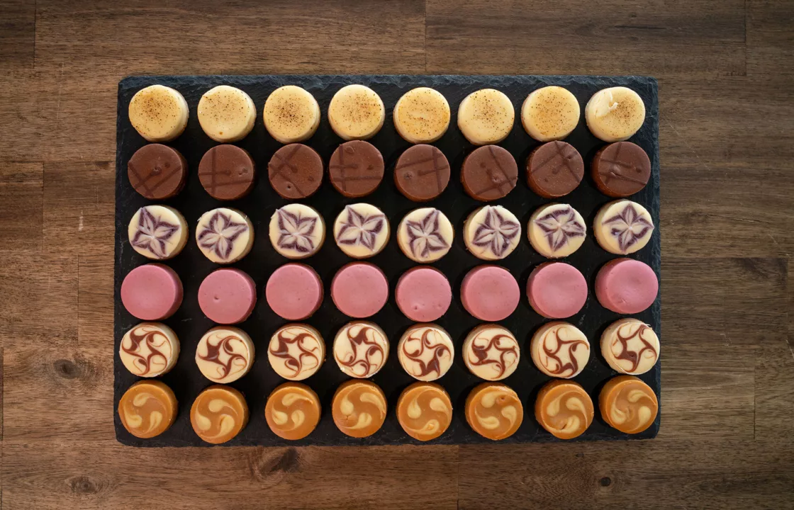 Aerial view of a selection of different flavoured macaroons served on a slate