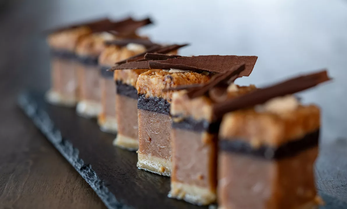 Close up of a selection of chocolate petite fours served on a slate
