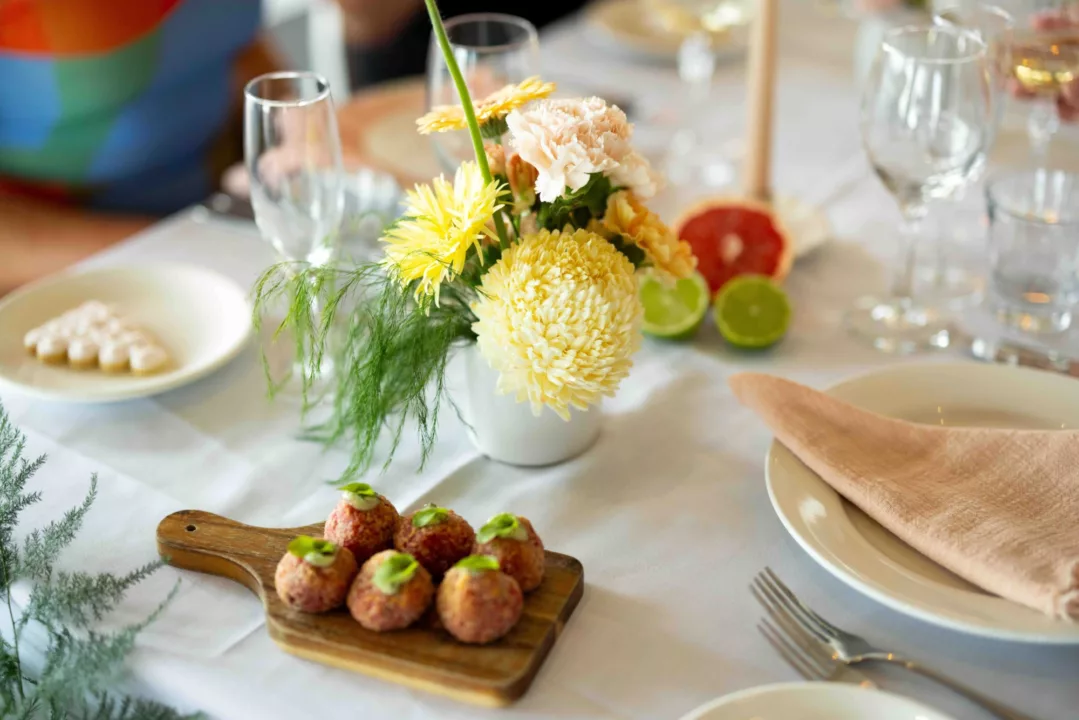 Canapes on table setting with flowers and glassware