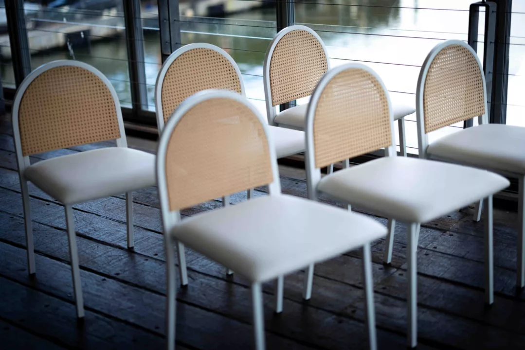 Reception chairs sitting on balcony in front of waterfront