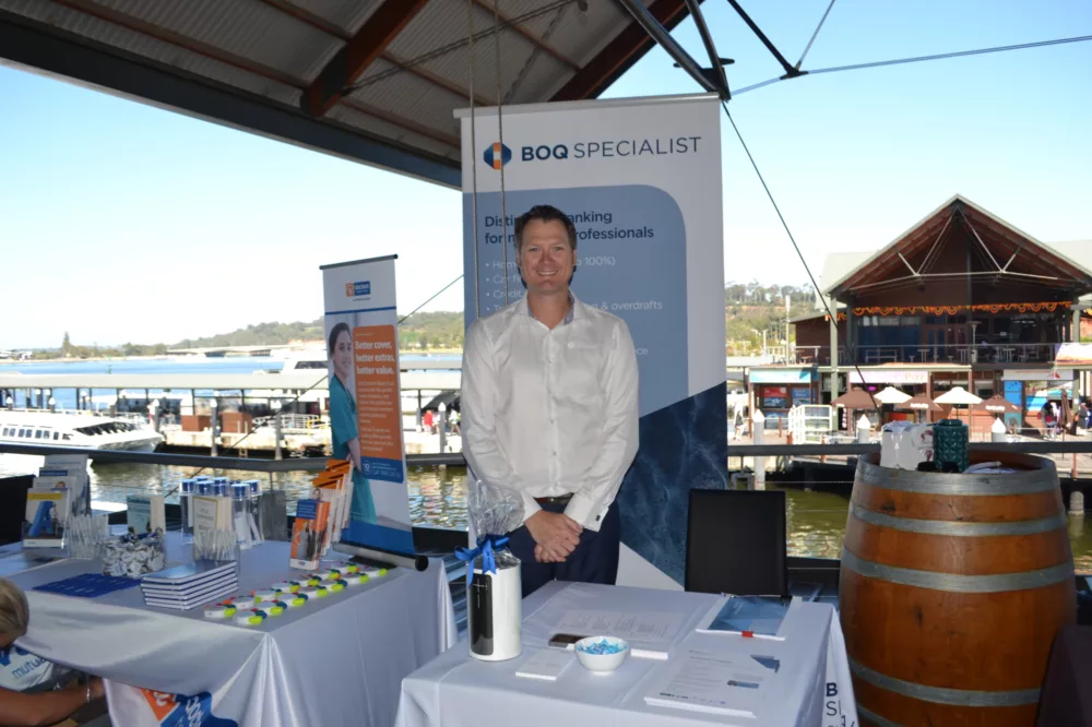 Man standing in front of a corporate presentation stand