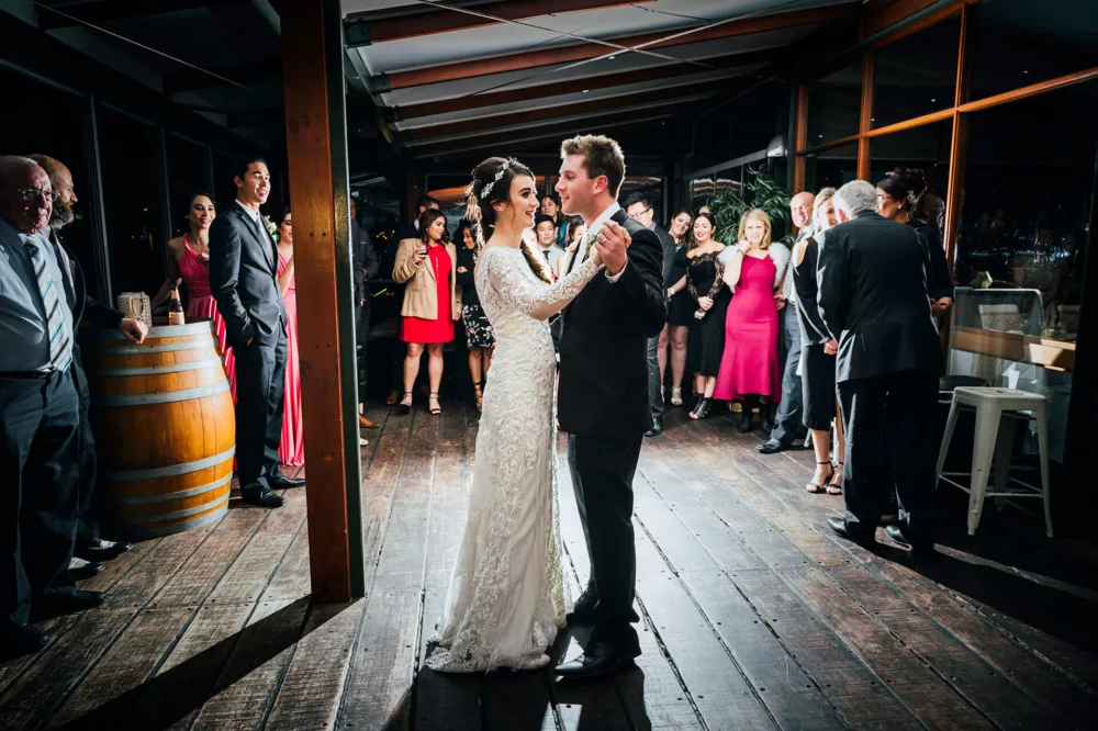 Bride and groom enjoy their first dance in a wedding venue