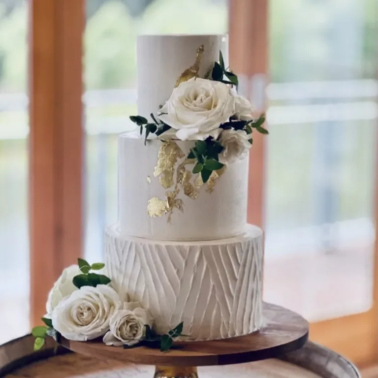 Takes The Cake wedding cake with flowers on a three-tier cake