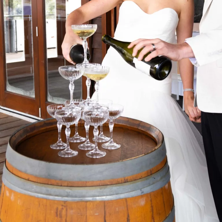 Wedding couple pouring champagne tower