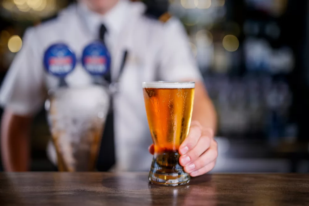 Barman serving Tooheys New beer on tap