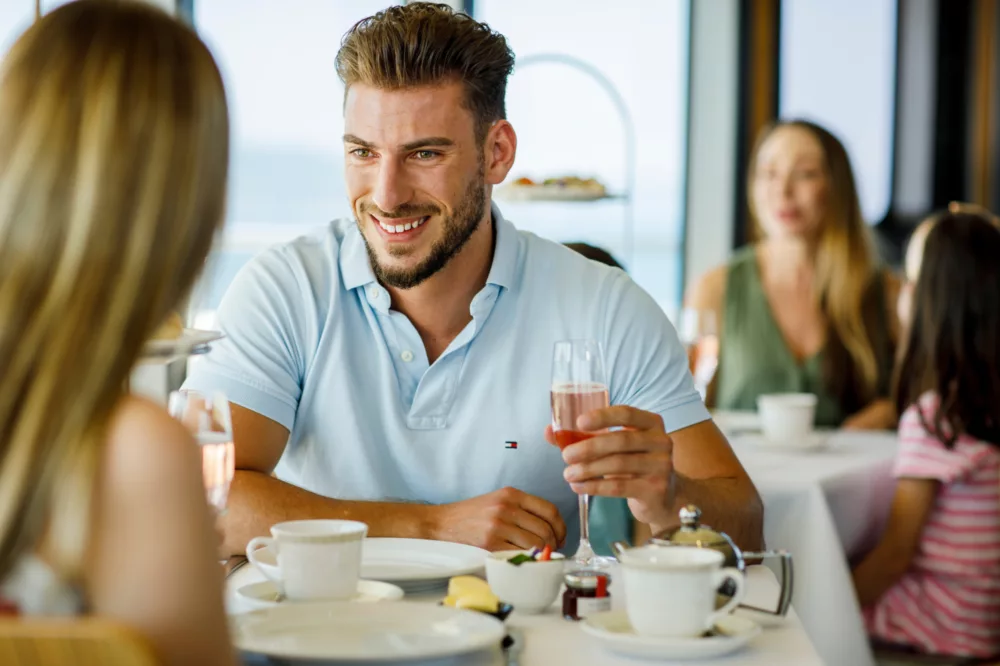 Guy LGBT man High Tea at Sea having pink bubbles