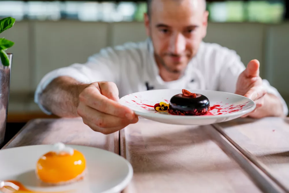 Chef preparing dessert plate food for dining dinner lunch premium
