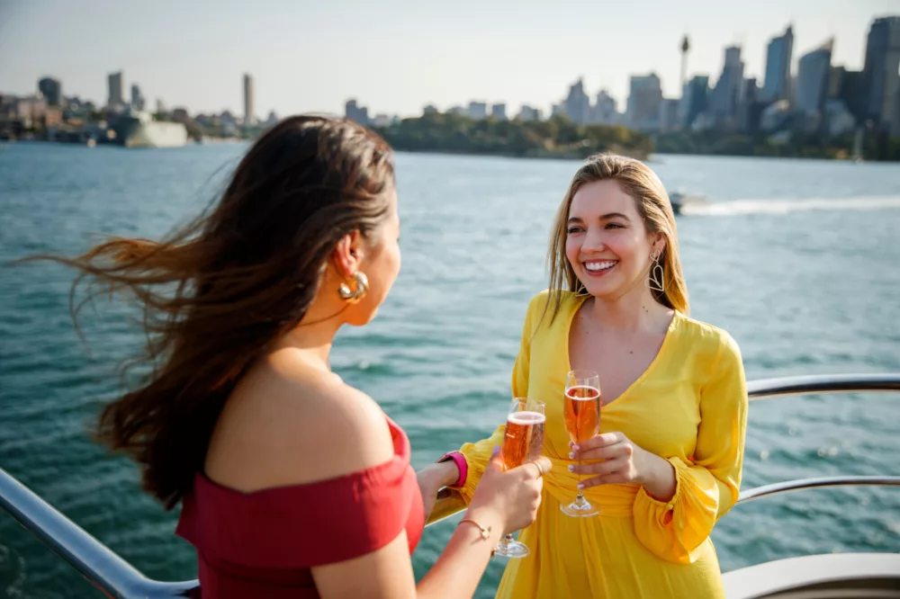 Girls ladies women having pink champagne enjoying harbour views experience