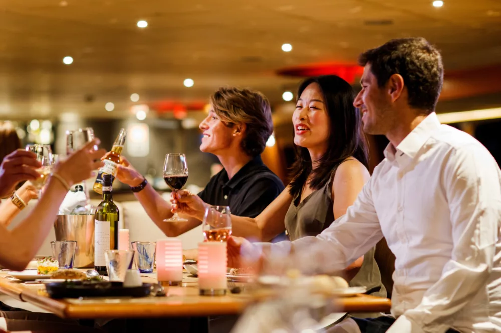 Group chatting and having Brilliant Dinner with wine dine drinks