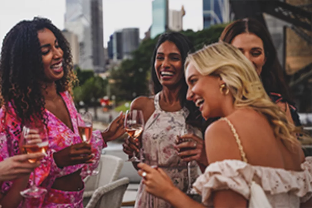 Ladies or Girls sipping Rose on the outdoor deck JX The Jackson
