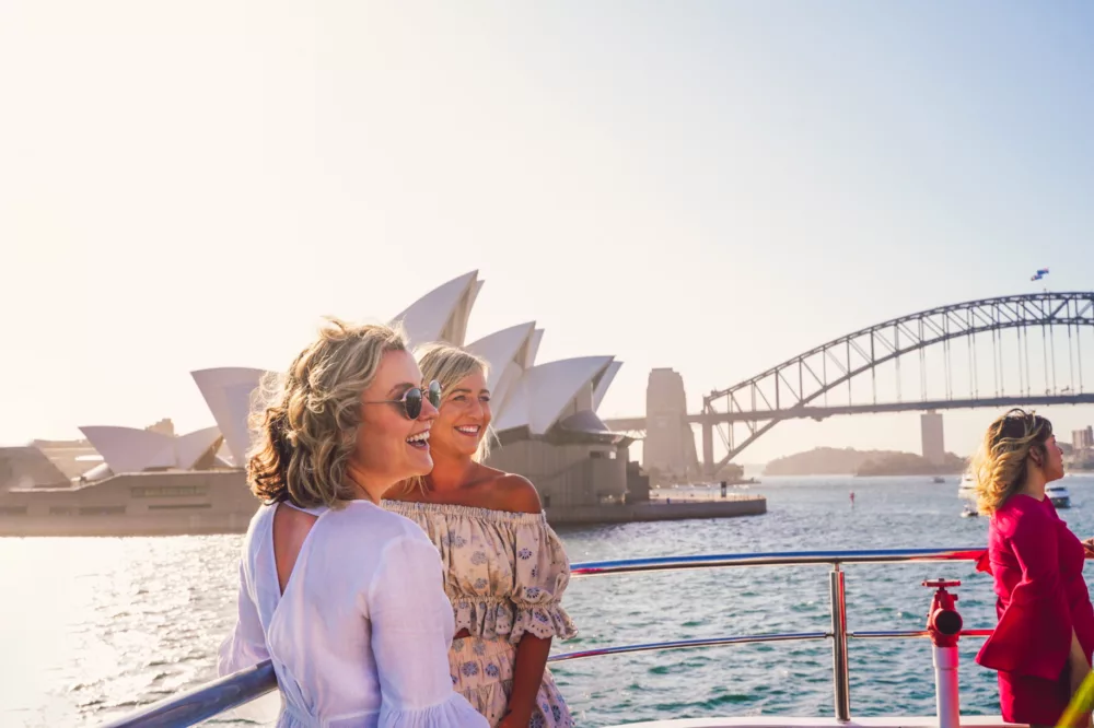 Two girlfriends enjoying the views from the open deck sightseeing casual bar