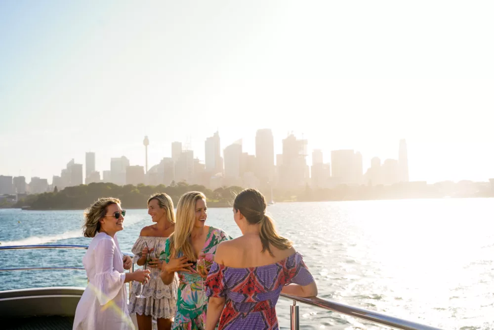 Group of girls chatting on open deck with city in the background sightseeing casual dining lunch daytime