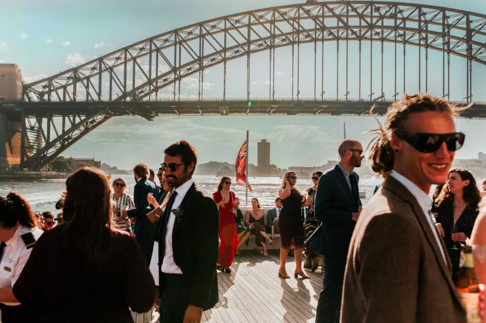 Charter onboard Captain Cook 3 wedding cocktail with Harbour Bridge in the background