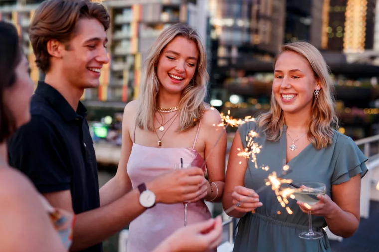 Groups of young friends celebrating birthday with Barangaroo in the background