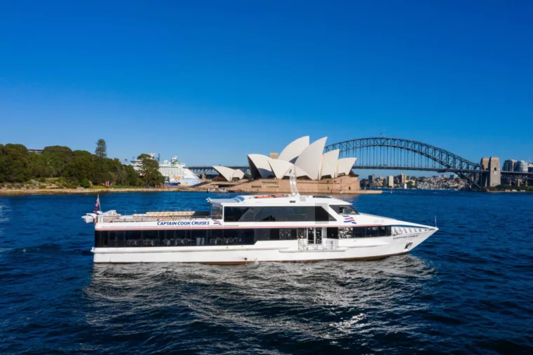 Captain Cook 3 boat CC3 profile shot during the day with Opera House and Harbour Bridge in the background