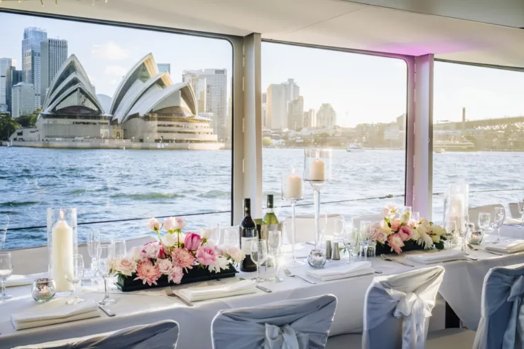 Captain Cook 3 wedding charter dining set up with Opera House in the background