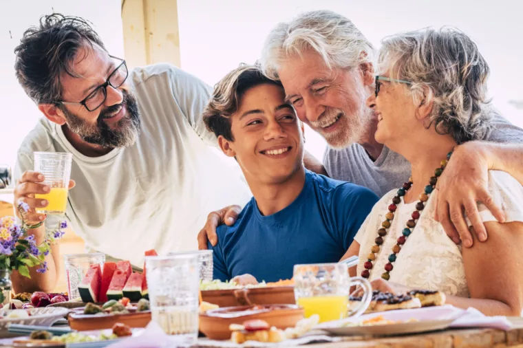 Family group grandfather senior, grandmother, son and grandson dining - stock