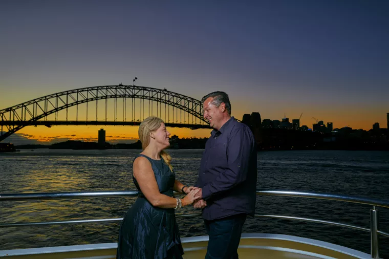 Couple valentines onboard Club Deck with sunset in the background with Harbour Bridge special occasion anniversary
