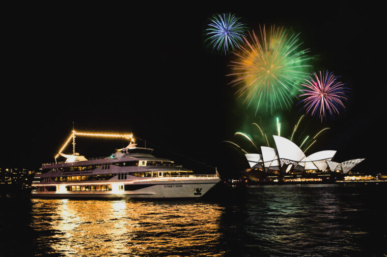 Sydney 2000 boat exterior cruising by Opera House at night with fireworks in the background doctored New Years Eve special events