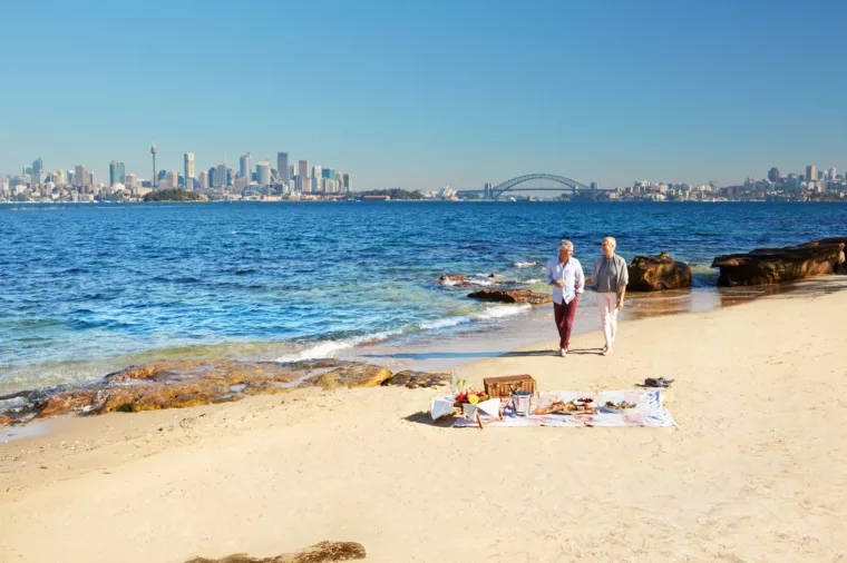 Senior couple walking on the beach in Shark Island ferry sightseeing HOHO non-ccc dnsw