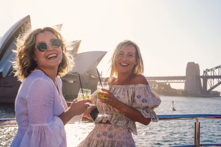 Girlfriends having cocktails drinks on the open deck
