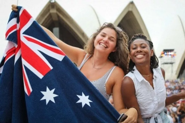 Two women holding flags to celebrate australia day at opera house special event non-ccc dnsw