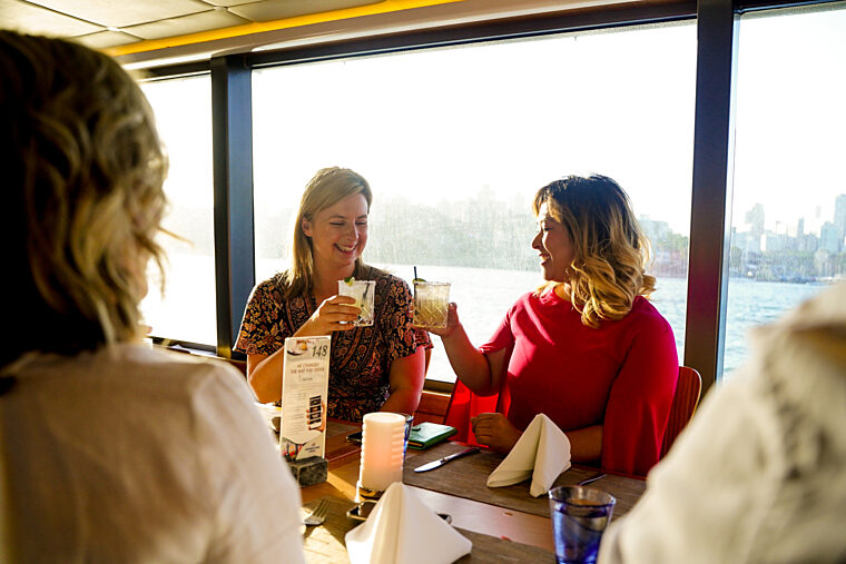 Two girl friends toasting cocktails in the Harbour Restaurant