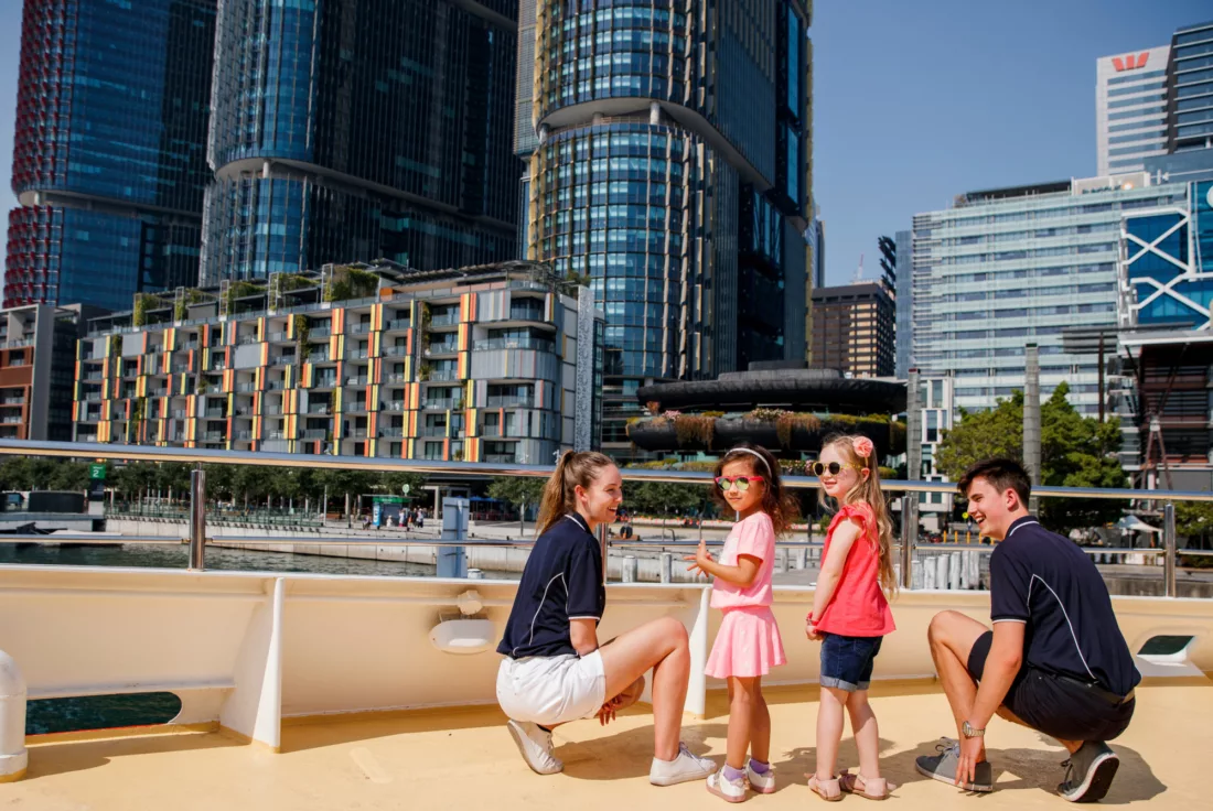 Sightseeing family children kids crew explore the harbour with Barangaroo in the background