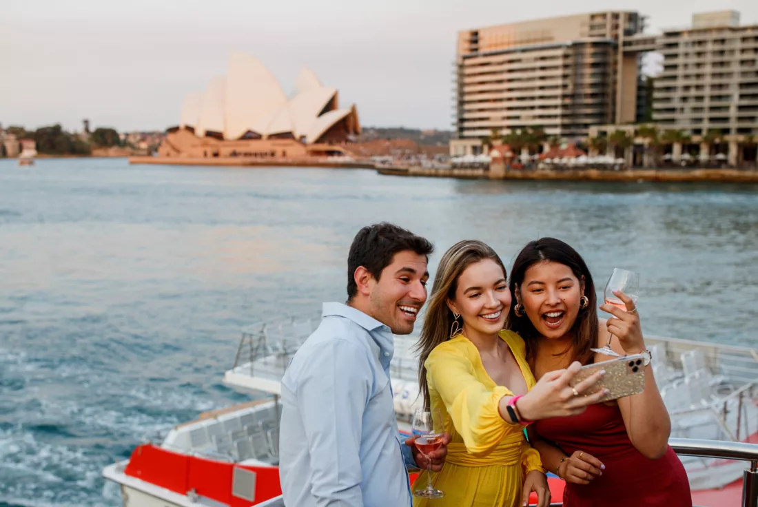 Young group taking selfie with Opera House in the background from Circular Quay
