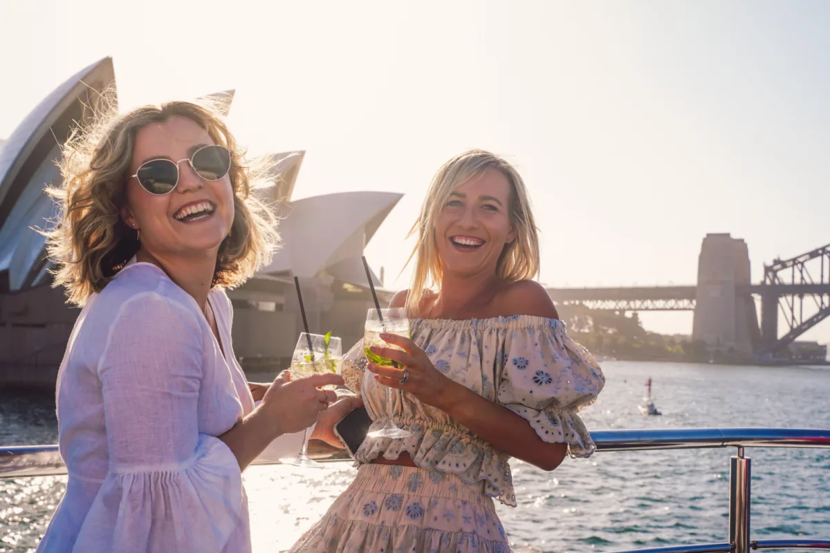 Girlfriends having cocktails drinks on the open deck