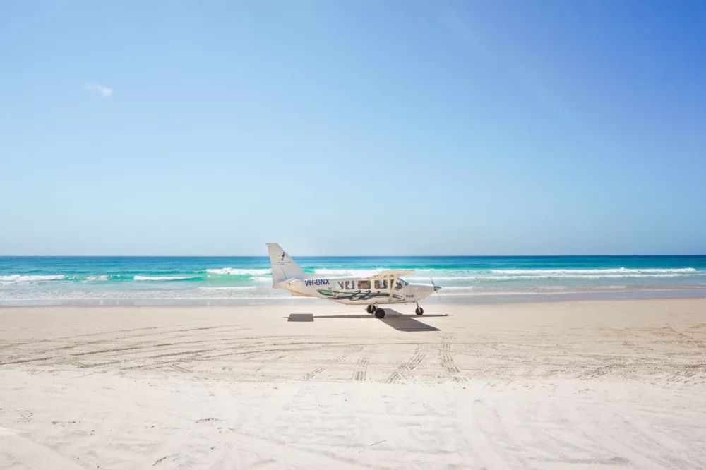 Air Fraser plane landing on 75 Mile Beach, K'gari (Fraser Island)