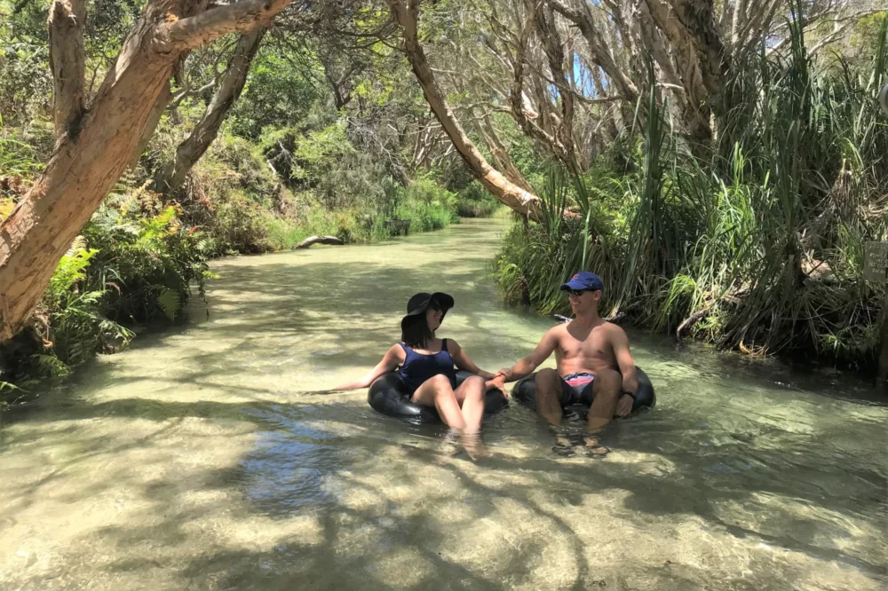 Couple floating down Eli Creek, K'gari (Fraser Island)