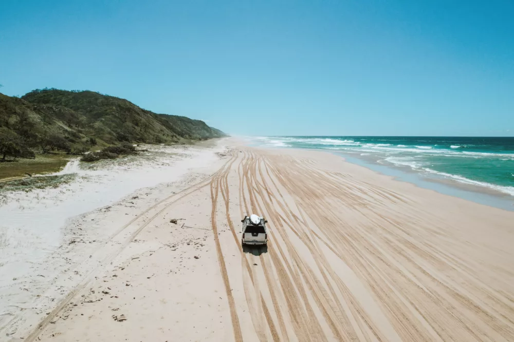 4WD driving down 75 Mile Beach, K'gari (Fraser Island)