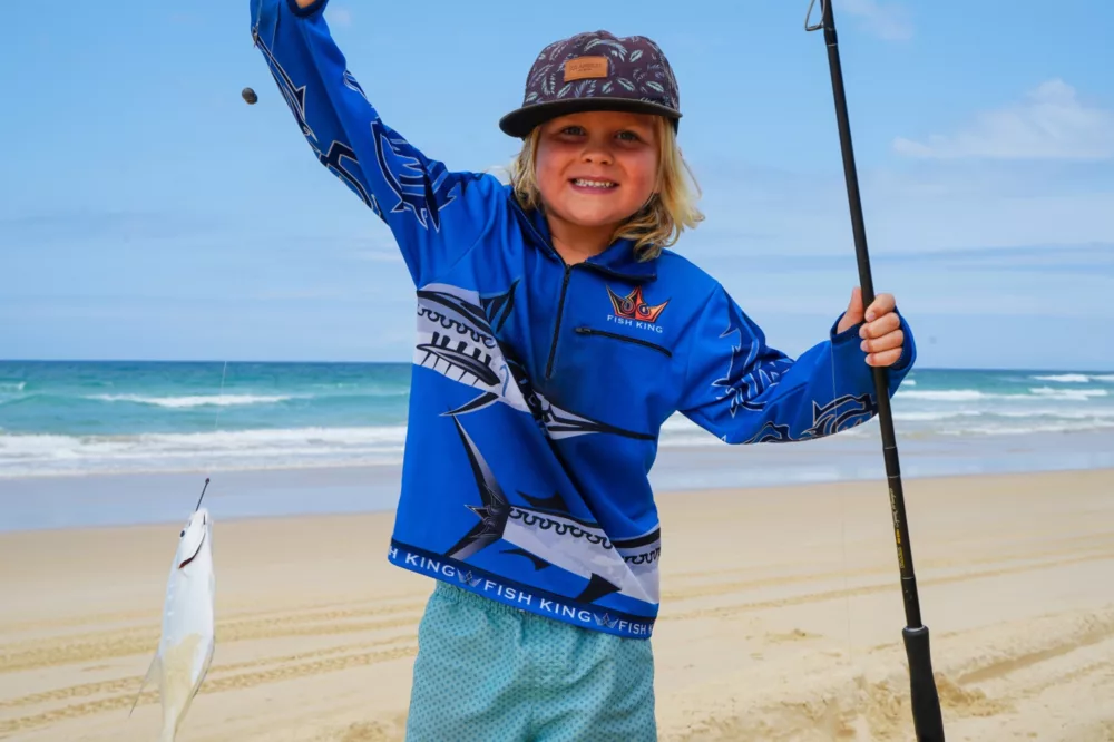 Kid holding fishing line with fish, K'gari (Fraser Island)