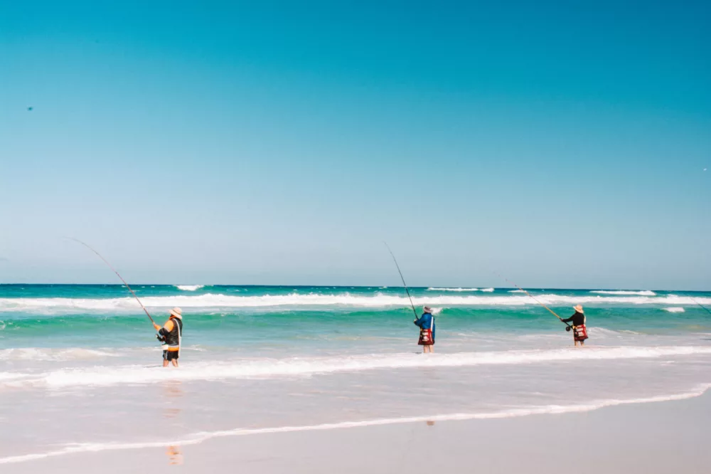 Three men fishing along 75 Mile Beach, K'gari (Fraser Island)