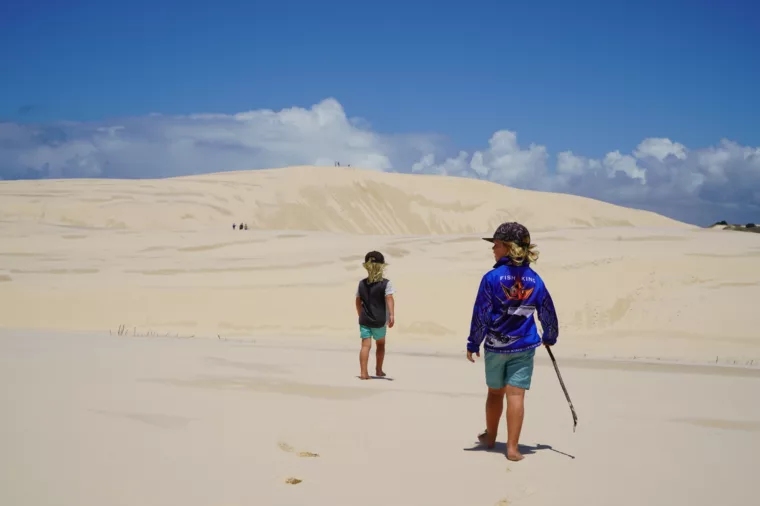 Kids climbing sand dunes at Lake Wabby, K'gari (Fraser Island)