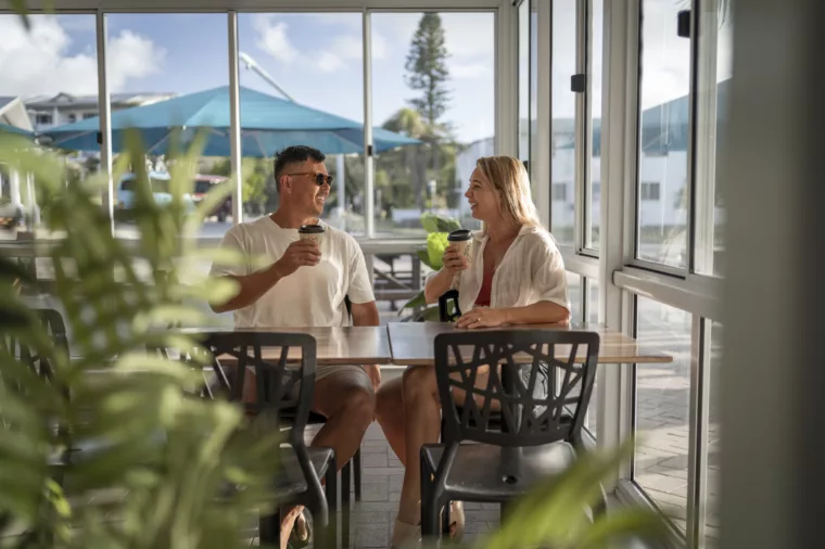 Couple sitting and drinking coffee in Eurong Bakery, K'gari Beach Resort, K'gari (Fraser Island)