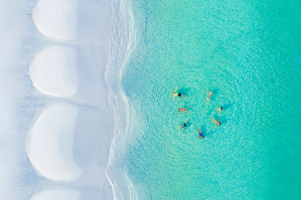 A group of friends enjoying the water of west coast K'gari Fraser Island