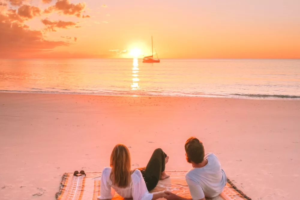 A couple enjoys a breathtaking sunset over the Great Sandy Strait