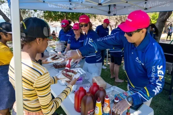 SeaLink staff serving BBQ