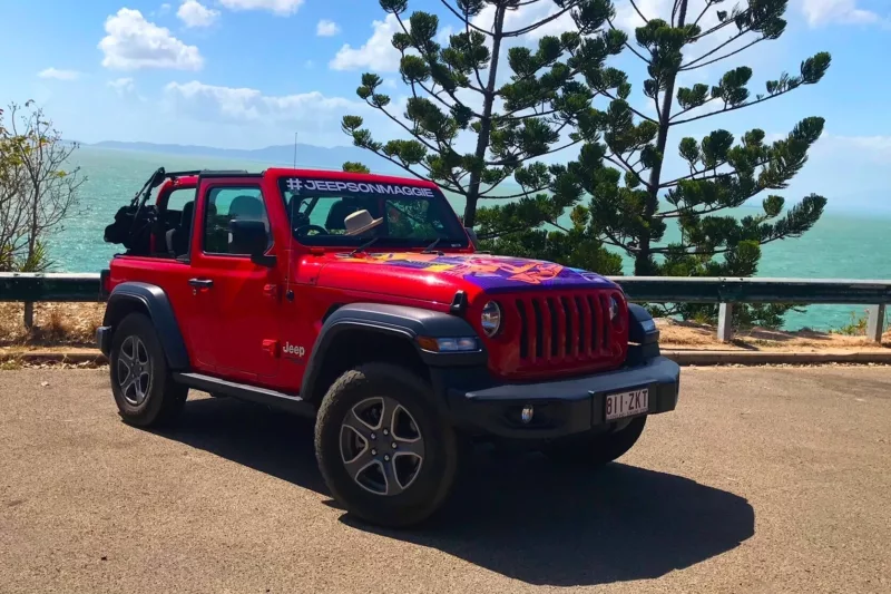 Image showcasing a rental red Jeep.