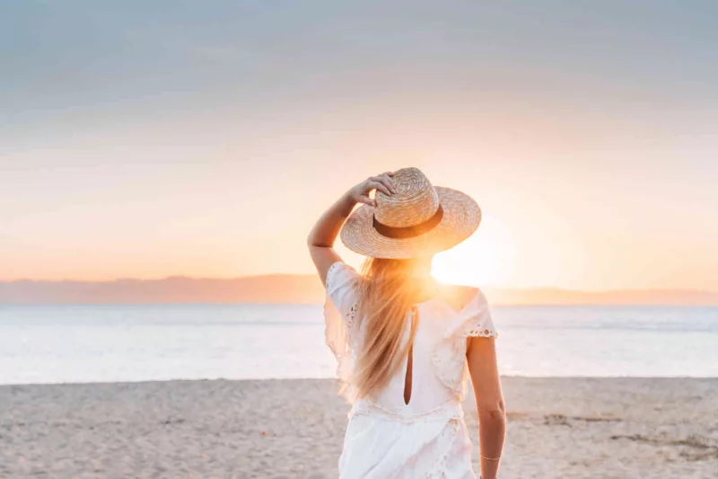 Girl on the beach looking at sunset