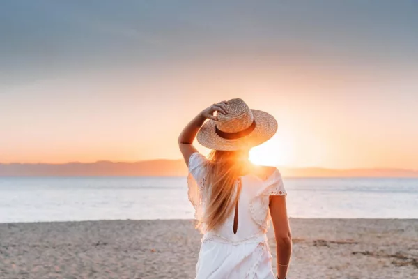 Image showcasing a woman wearing a hat on the beach at Magnetic Island.