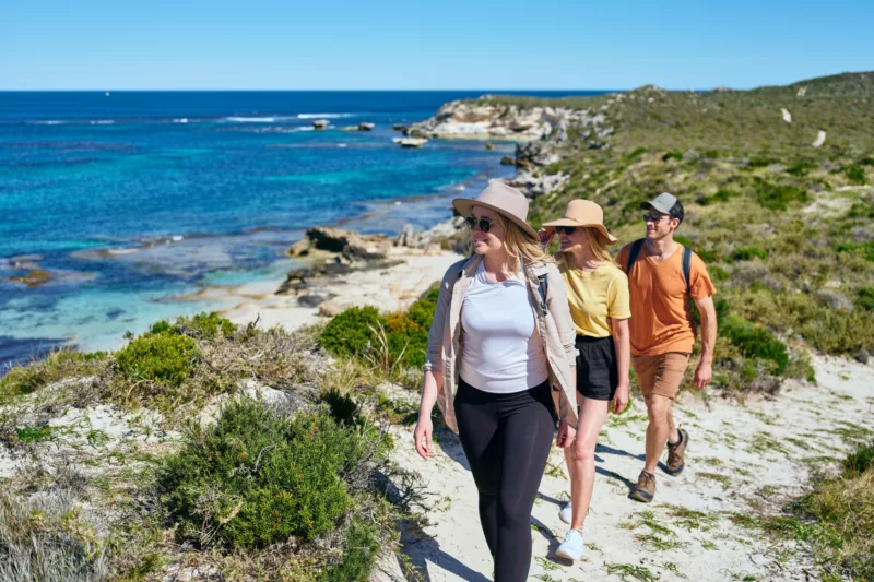 Three people walking along hiking track near Wilson Bay